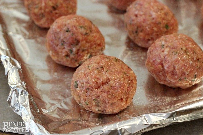 Sweet and Sour Ground Pork Meatballs by Renee's Kitchen Adventures raw on baking sheet ready for the oven