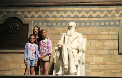 A Group Poses Next to Darwin, Girl Sneaks a Peak at Darwin