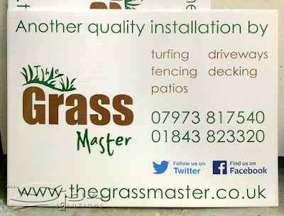 Another quality installation by The Grass Master, in green with the logo below it. The second column the sign has the points of jobs they take on, turfing, driveways, fencing, decking and patios. Below that is the two phone numbers in green, 0797381754 and 01483823320. Under that has the follow us on Twitter and Find us on Facebook social media logos. The finial line has the website address stretching across the width of the correx, www.thegrassmaster.co.uk