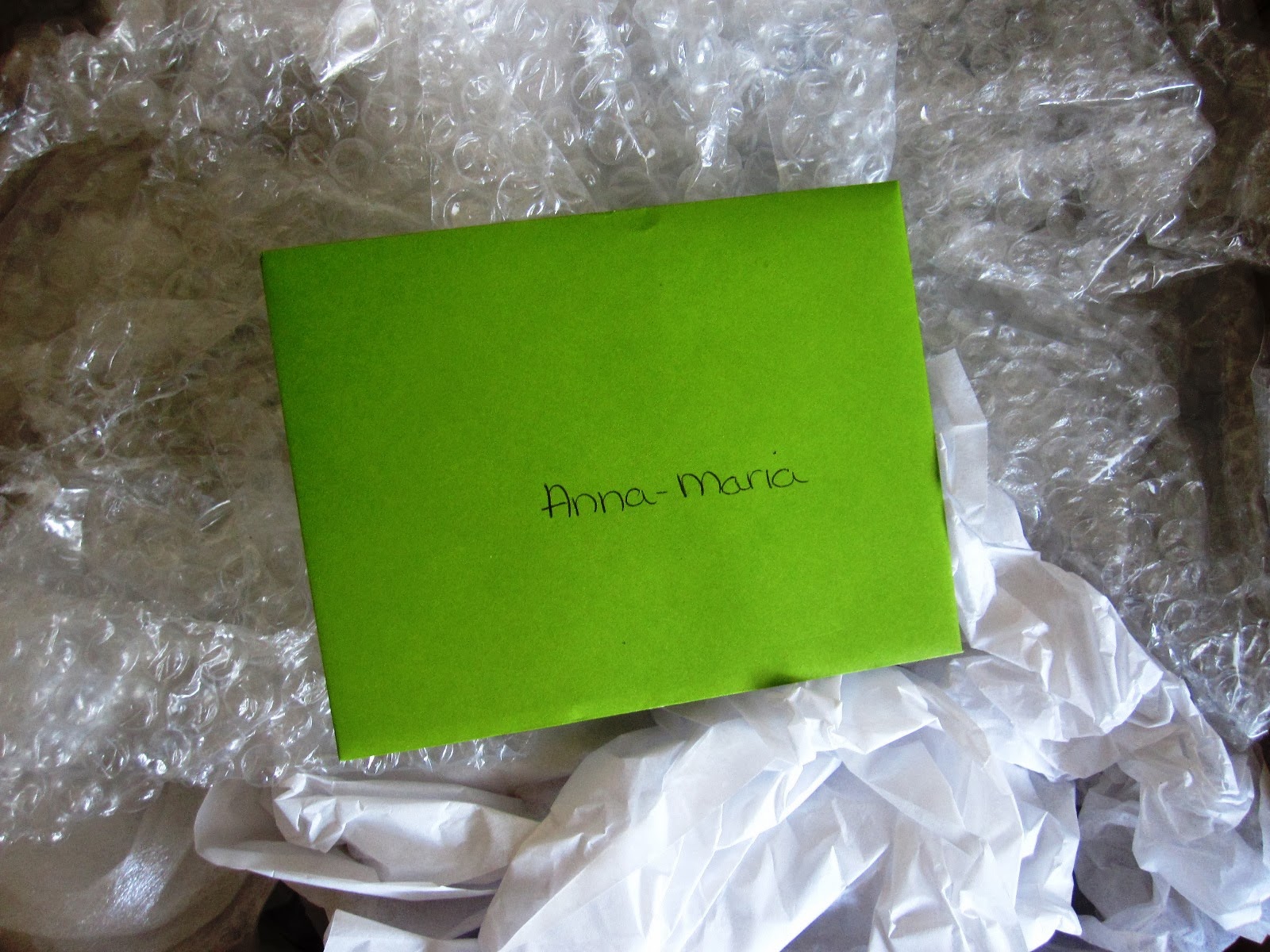 Inside of swap parcel, showing bubble wrap and an envelope with Anna-Maria written on it