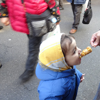 Malla eating unagi on a stick outside Tsukiji Fish Market Tokyo