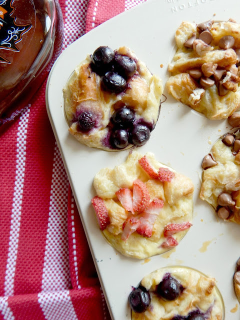 Croissant French Toast Cups...the hit at your next brunch or breakfast!  Croissants are soaked up in a delicious custard then topped with an array of toppings - blueberries, strawberries or chocolate chips and pecans. (sweetandsavoryfood.com)