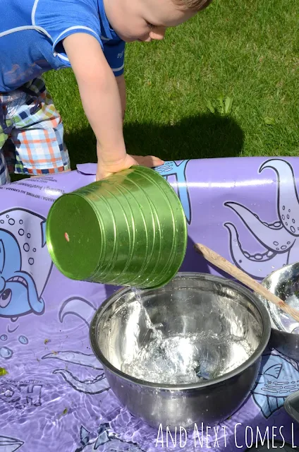 Child pouring water in a kiddie pool as part of a music science activity for kids