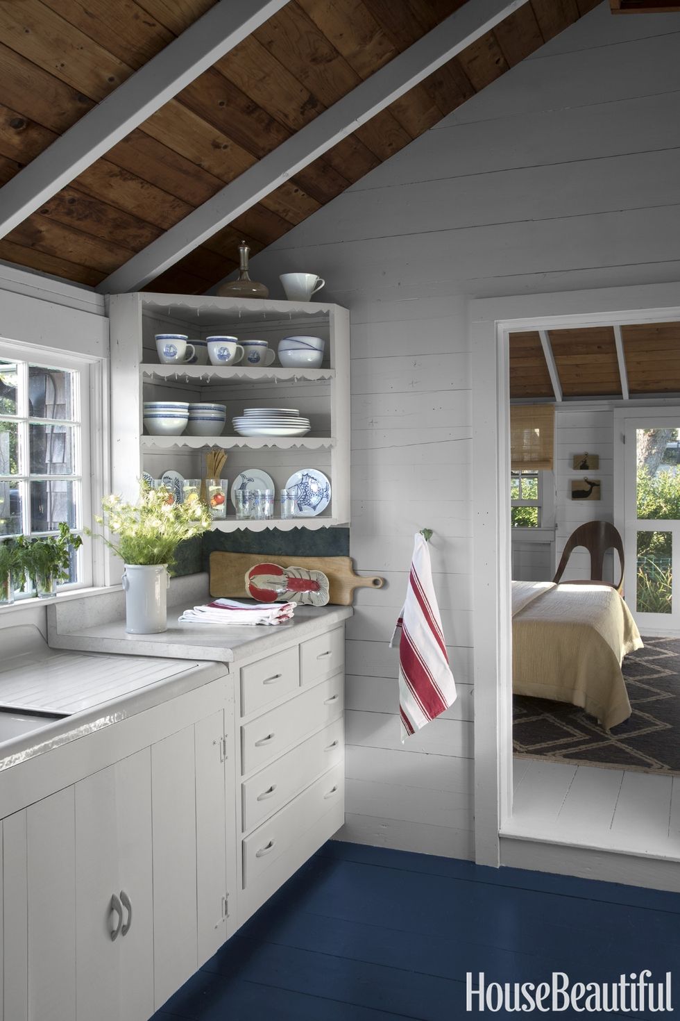 Red, white, and blue decor in a Nantucket rustic kitchen. COME TOUR MORE Nantucket Style Chic & Summer Vibes! #nantucket #interiordesign #designinspiration #summerliving #coastalstyle