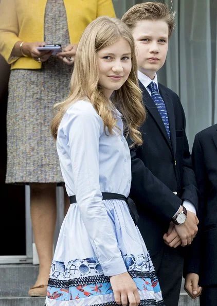 Crown Princess Elisabeth wore Zara fringed coat, Maje Poplin dress, Diane von Furstenberg floral trousers, Maje Raphael dress. Queen Mathilde