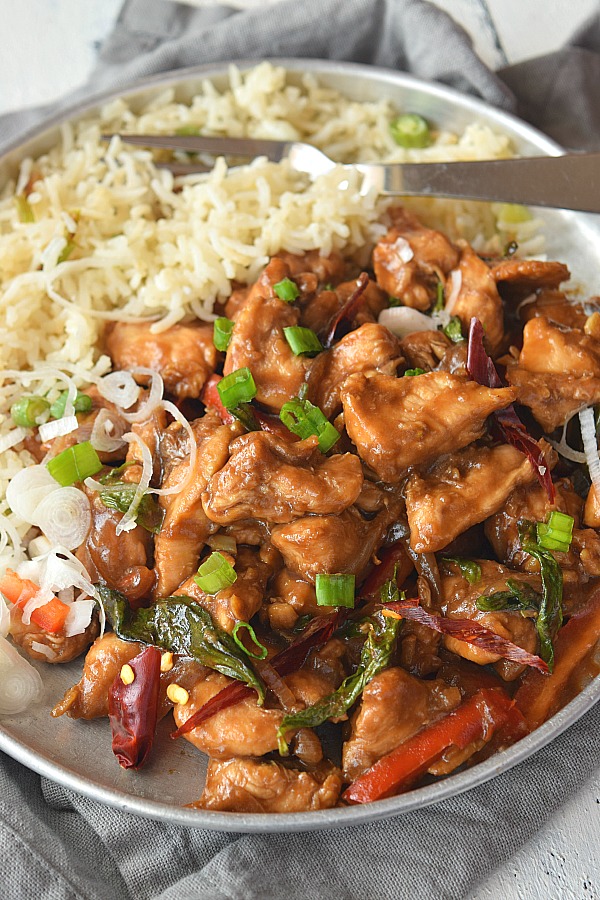 A close look of Thai spicy Basil Chicken topped with green onion