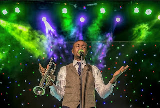 Nathaniel bassey on stage to minister