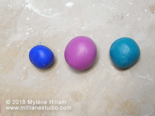 Balls of epoxy resin clay coloured with alcohol inks