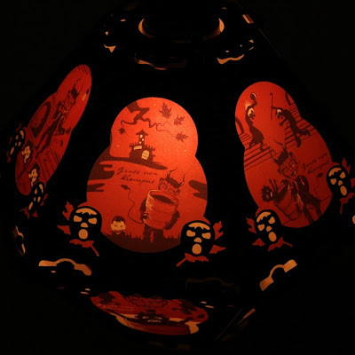 This 12 side lantern by Bindlegrim offers art in red, black, white illustration of Europe Christmas tradition the Krampus