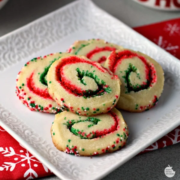Santa's Swirl Sugar Cookies | by Renee's Kitchen Adventures - Easy holiday cookie recipe that transforms sugar cookies into a festive sweet treat with red and green colored sugars!