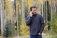Man on a cellphone in a forest