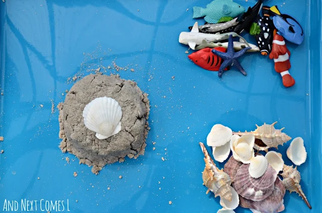Ocean themed invitation to play using sand foam sensory dough