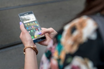 Fashion girl use her smartphone on the street