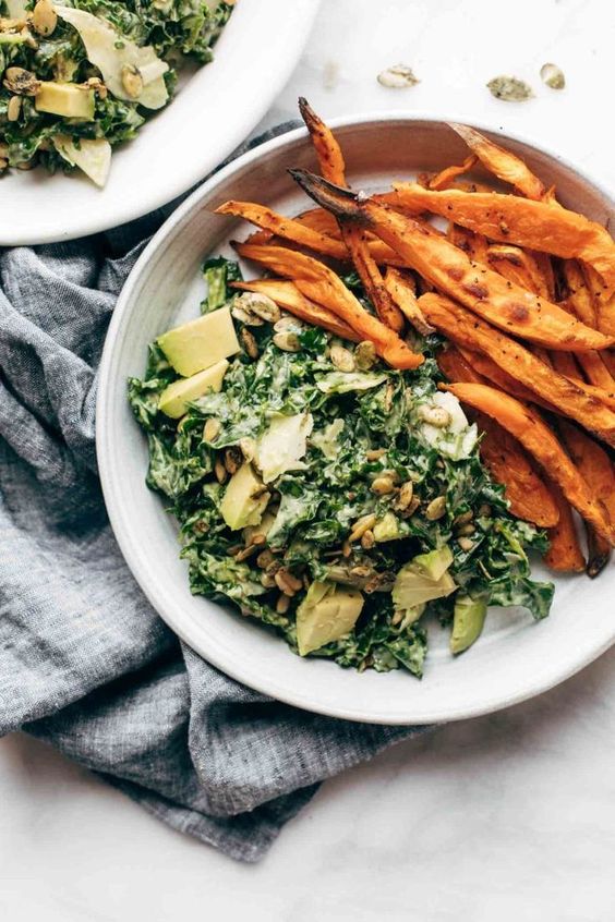 Avocado Kale Caesar Salad! Kale, avocado, and crunchy seeds drenched in a quick creamy avocado caesar dressing that can easily be made vegan, too. Toss some crispy sweet potato fries in are you are…
