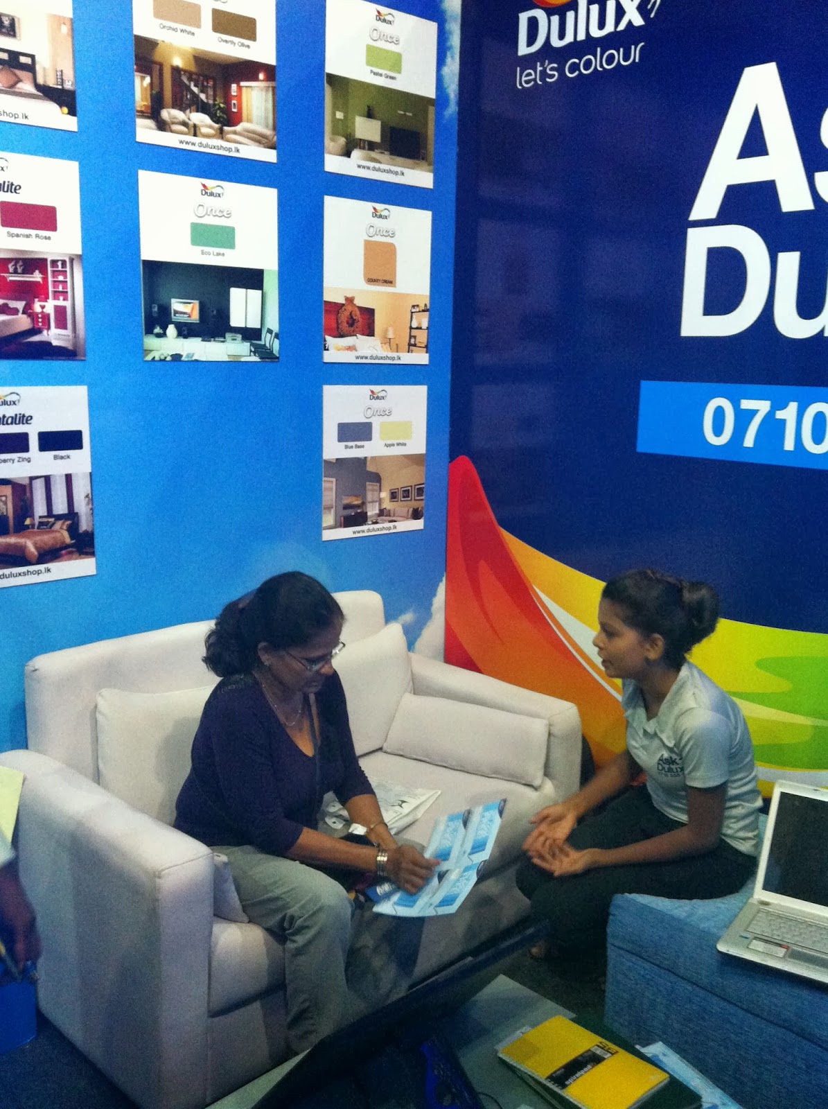 Visitors at the Dulux consultation lounge seek advice on paint choices .