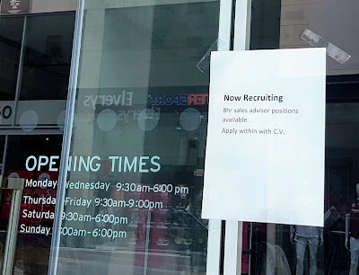 sign in shop window with job details and topshop galway store opening times