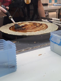 spicy sauce being applied to crepe;  crepe village