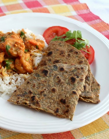 Food Lust People Love: A spicy twist on traditional plain paratha made with wholemeal wheat flour and seasoned with onion, garlic, chili peppers and cilantro as well as ground coriander and garam masala and cooked on a hot griddle.