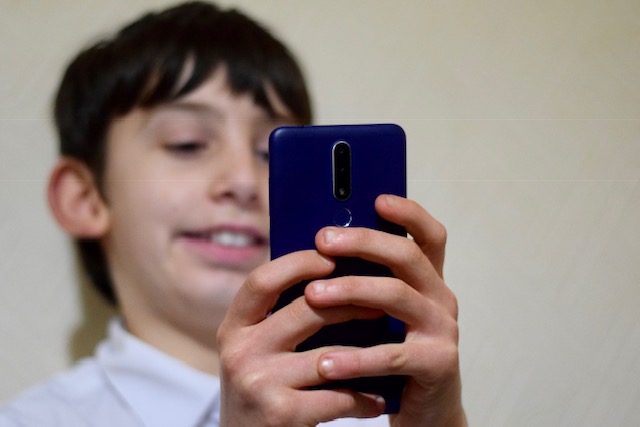 Tween boy with Nokia 3.1 plus Andriod one smartphone - blue