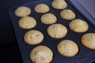 Crispy brown corn bread muffins fresh from the oven in a muffin baking pan.