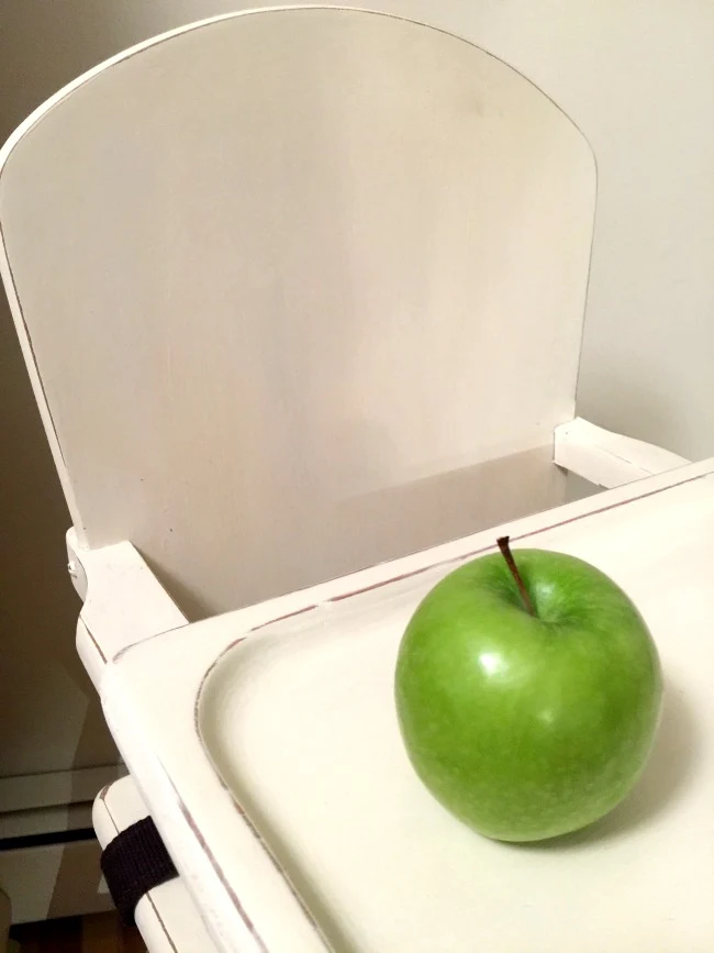 Wooden chair and green apple