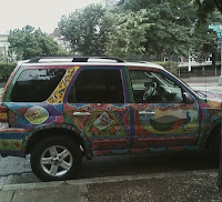 side view of car with bright painted designs on doors and roof