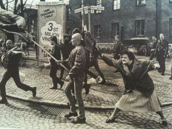 52 photos of women who changed history forever - A Swedish woman hitting a neo-Nazi protester with her handbag. The woman was reportedly a concentration camp survivor. (1985)