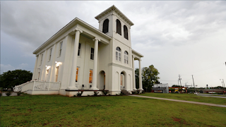 A large black and white image of The Drish House structure