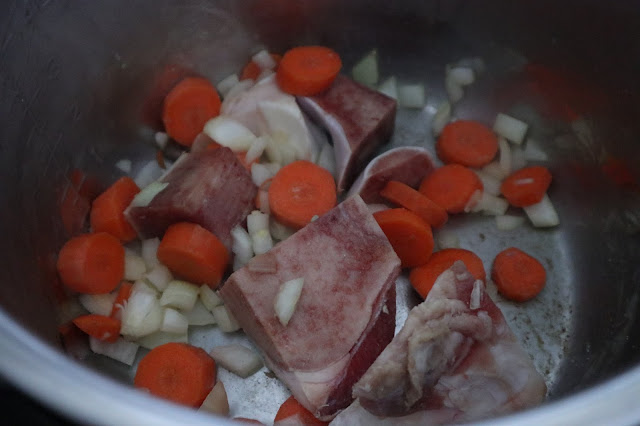 carrots, beef bones, onions sauteing in the instant pot