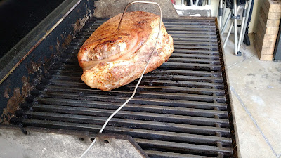 Unwrapped pork shoulder grilling.