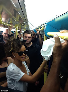 Pictures Of Rihanna riding the London tube with her fans: Damn she couldnt even get a seat. 21