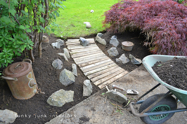 How we went from dirt to a beautiful pallet wood garden walkway - from start to finish! Click to read full tutorial.