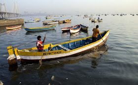 fishermen boat rowing arabian sea worli jetty mumbai koliwada india