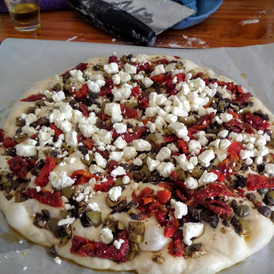 Focaccia Pizza:  An Italian flat bread made with a wet dough, shaped into a pizza, and topped with tapenade, sun-dried tomatoes, and feta cheese (or toppings of your choosing).