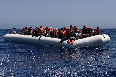 Heart-wrenching photos of migrants being flipped into the sea as their overcrowded boat overturns off the coast of Libya