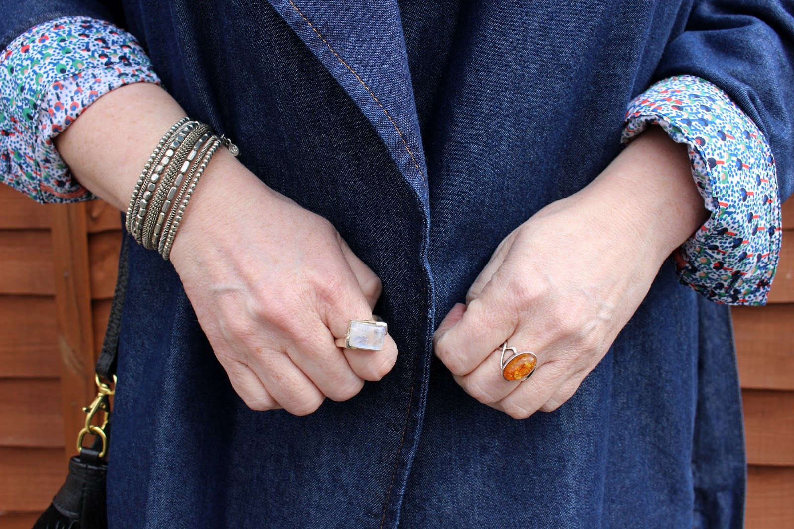 Moonstone Ring, Amber Ring, Grey Spiral Bracelet against Denim Coat | Petite Silver Vixen