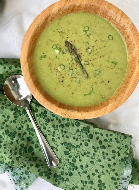 Close-up of a bowl of creamy spring asparagus soup.