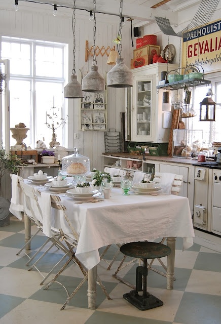 Vintage cabinets and industrial lighting and signage combines country styles in this kitchen
