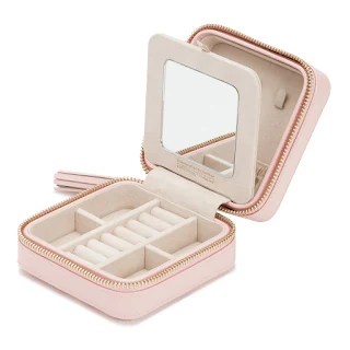 A small rose quartz leather box with a zip around the middle, places to store jewellery and a mirror