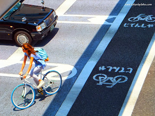 woman bicycle lane tokyo Japan