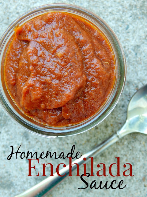 Red enchilada sauce in a glass mason jar with a spoon