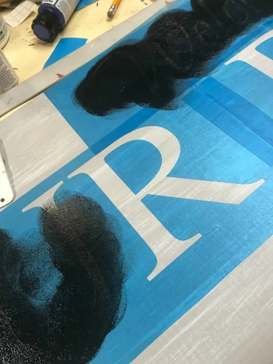 Painting in the stencil with black