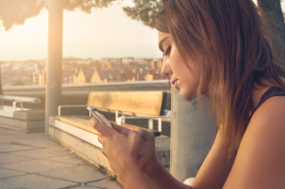 teen girl looking at phone