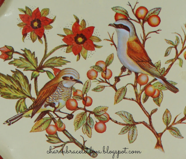 tin tray with red birds berries and flowers