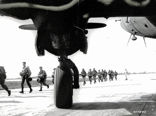 US Army soldiers getting ready to board plane for parachute practice at Lipa Airstrip.  Image source:  United States National Archives.