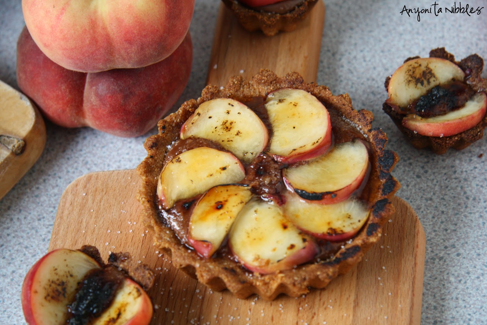 Overhead of brûléed peach & Nutella tarts by Anyonita Nibbles