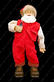 Figurine of standing Santa Claus holding a bottle of Coca-Cola on black background