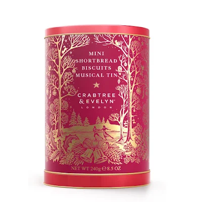 A tin of biscuits in red and gold with a Christmas theme