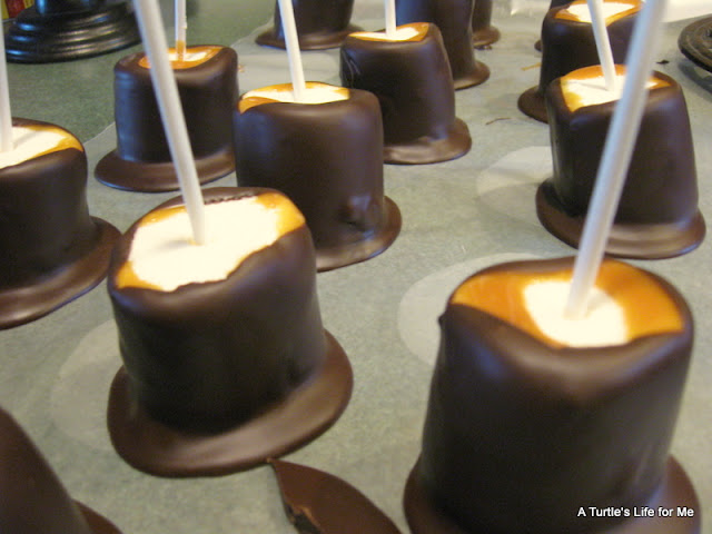 A process shot  showing a  recipe for chocolate caramel marshmallows. The image shows the marshmallows on a  baking sheet after having been dipped in caramel and chocolate. 