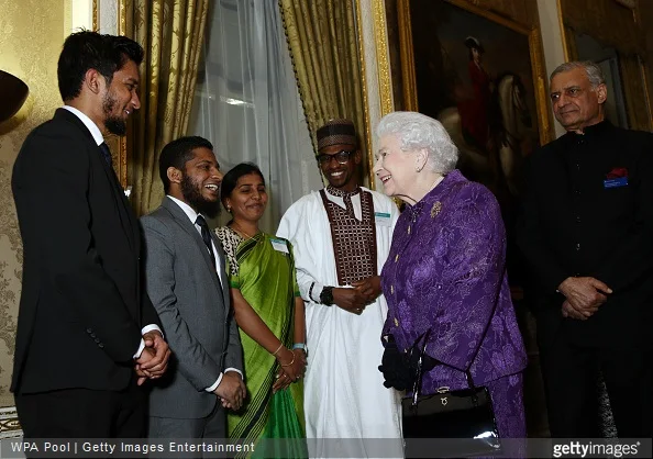 Elizabeth II speaks with guests during a reception to mark Commonwealth Day at Marlborough House